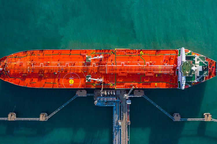 A tanker ship photographed from the air being unloaded in port (copyright by Shutterstock/Avigator Fortuner)