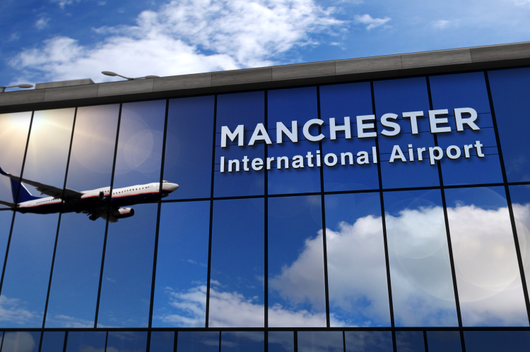 Terminal of Manchester International Airport with the reflection of an airplane (© Shutterstock/Skorzewiak)