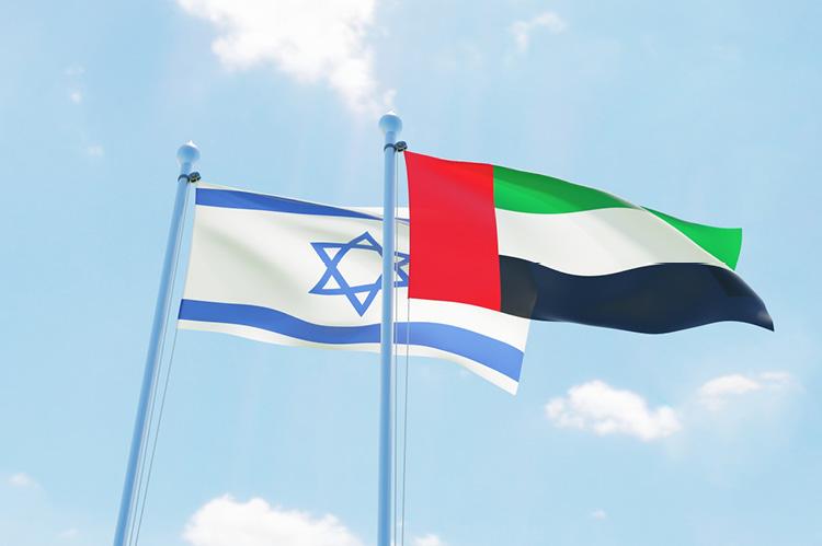 United Arab Emirates and Israel, two flags waving against blue sky (copyright by Shutterstock/Sasha_Strekoza)