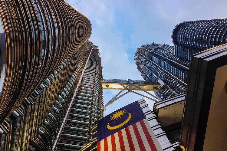 Petronas Towers with Malaysia national flag (© Shutterstock/sacitarios)